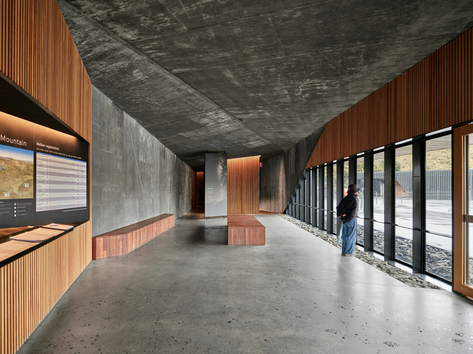 Contemporary interior combining exposed concrete with dark timber accents